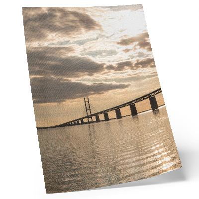 Poster A bridge over the water in the light of the setting sun