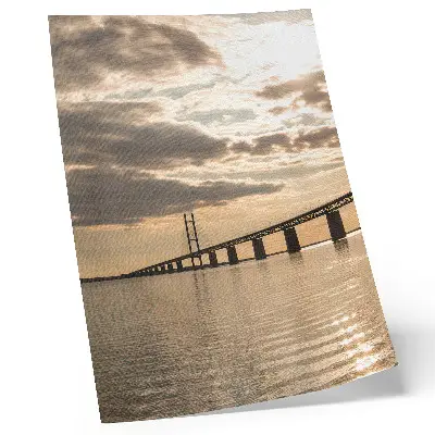 Poster a bridge over water at sunset