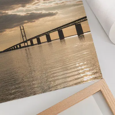 Poster a bridge over water at sunset