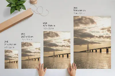 Poster a bridge over water at sunset