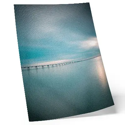 A bridge over calm blue waters poster