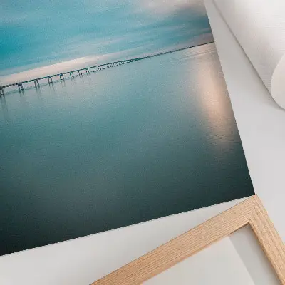 A bridge over calm blue waters poster