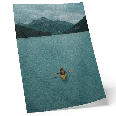 Premium wall art featuring a peaceful turquoise lake with a kayaker and mountain scenery