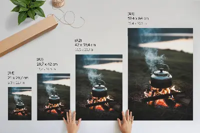 Decorative poster kettle over a fire in the forest by the lake