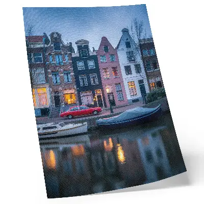 Art print colorful tenement houses in the evening atmosphere reflected in the water