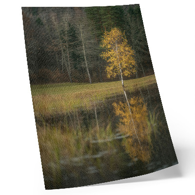 Decorative poster golden tree against a dark forest and lake background