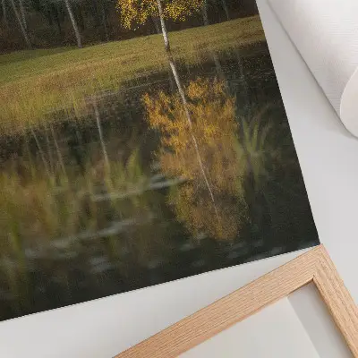 Decorative poster golden tree against a dark forest and lake background
