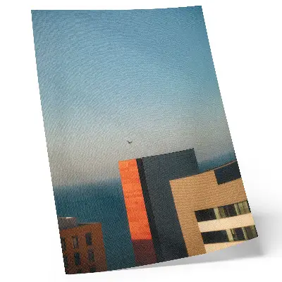 Decorative poster featuring a modern coastal scene with buildings and birds in a vast sky