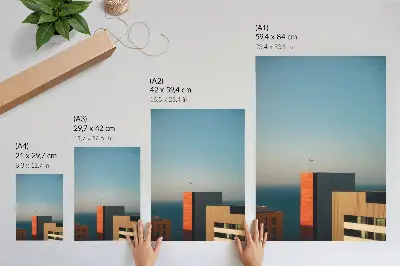 Decorative poster featuring a modern coastal scene with buildings and birds in a vast sky