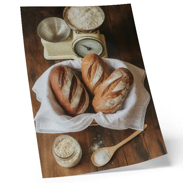 Poster bread basket with flour and a scale on a wooden surface