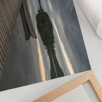 Decorative canvas print featuring a calming lake scene with a boat, forest, and clouds