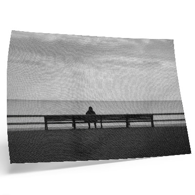 Decorative canvas print Person on a bench by the sea gray harmony