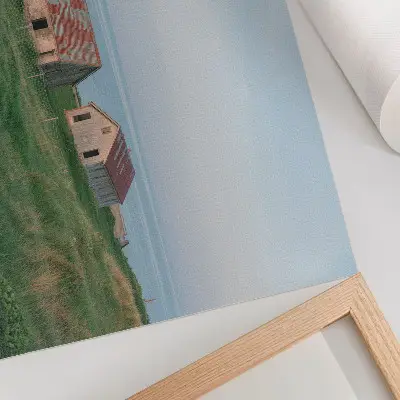 Poster rustic buildings with green meadows and sea