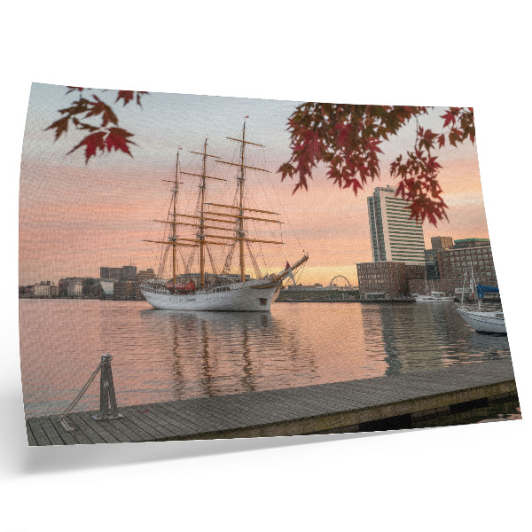 Decorative canvas print A sailing ship at sunset, a peaceful panorama of the city