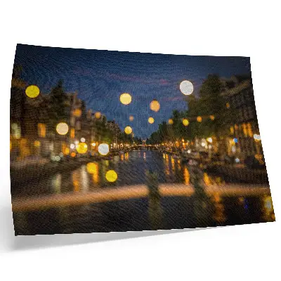 Poster a charming city at night with lights reflected in the water