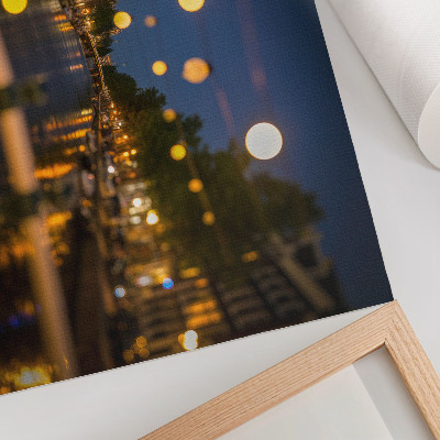 Poster A charming city at night, lights reflected in the water