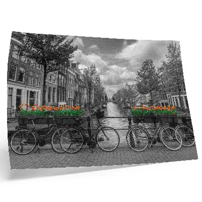Decorative canvas print a charming canal view with bicycles and tulips in black and orange