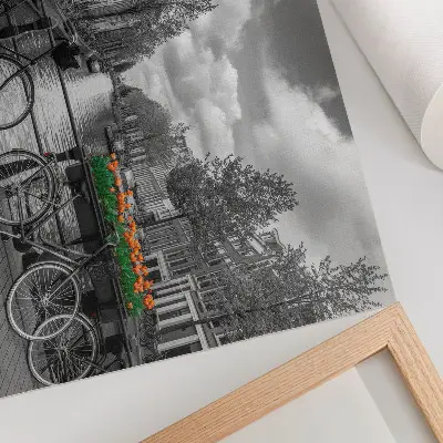 Decorative canvas print a charming canal view with bicycles and tulips in black and orange