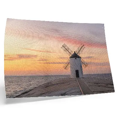 Poster windmill in the sunset light with a pastel sea sky