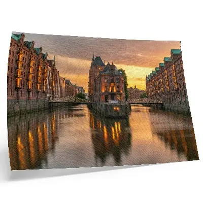 Decorative canvas print calm water reflecting brick buildings in warm light