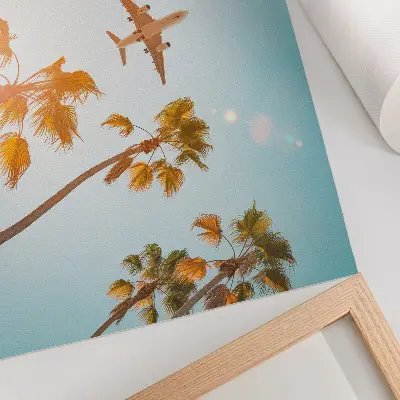 Poster airplane flying over tropical palm trees under a blue sky