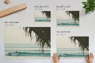 Decorative canvas print featuring a peaceful beach scene with surfing waves and palm trees