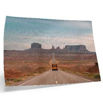 Decorative canvas print straight road with monumental mountains in warm colors
