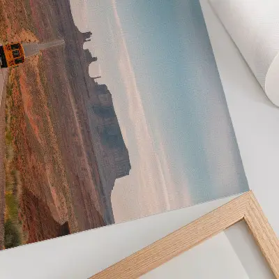 Decorative canvas print straight road with monumental mountains in warm colors