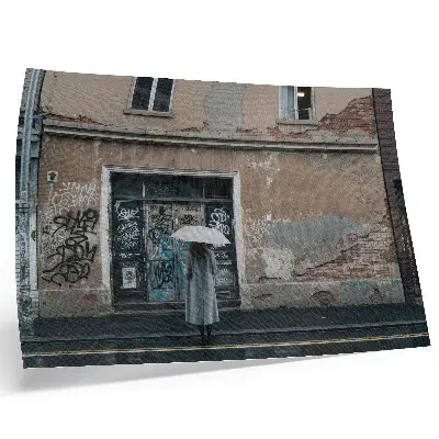 Decorative canvas print person with an umbrella in front of a graffiti wall