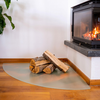 Glass wood burner hearth in a semi-transparent quarter circle shape