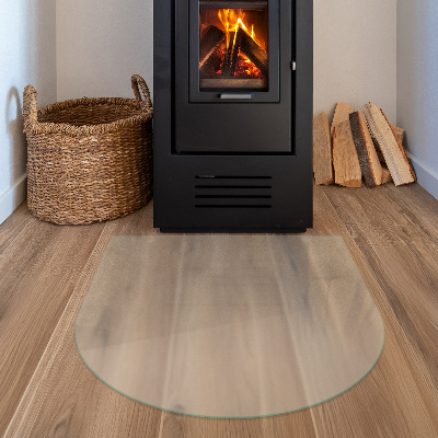 Glass hearth plate in a semi-transparent semi-oval shape