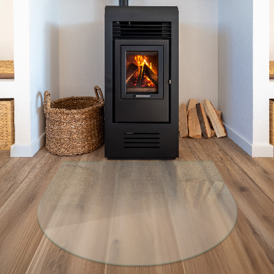 Glass hearth plate in a semi-transparent semi-oval shape