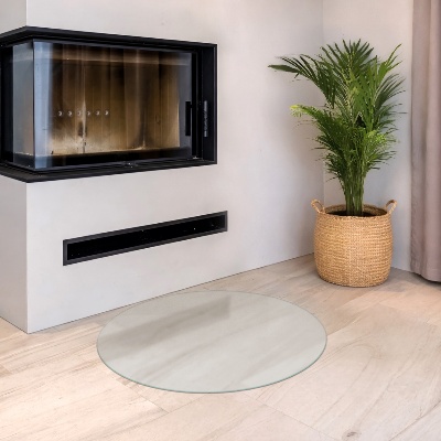Glass hearth pad in a round semi-transparent design