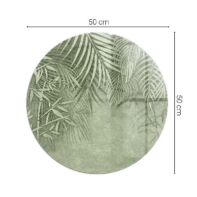 Glass hearth for stove round Tropical leaves in the background