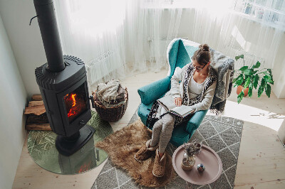 Glass hearth for stove round Tropical leaves in the background