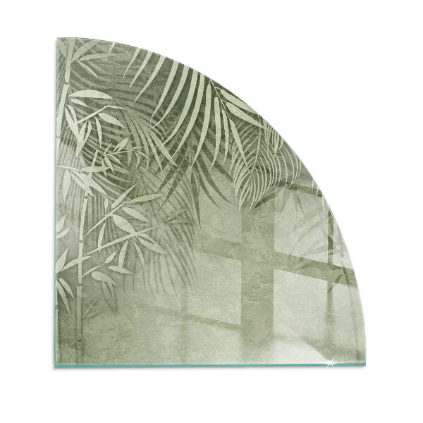 Glass hearth for log burner quarter Tropical leaves in the background