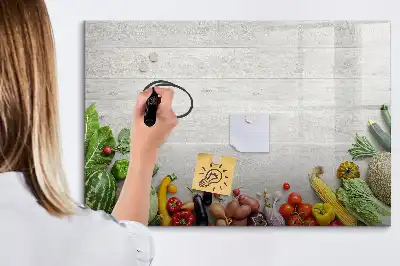Magnetic marker board featuring a table with vegetables