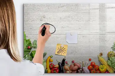 Magnetic marker board featuring a table with vegetables