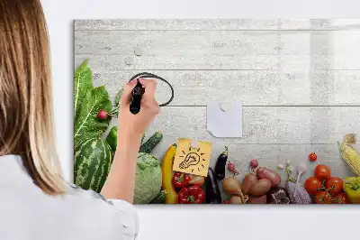 Magnetic marker board featuring a table with vegetables