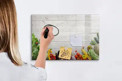 Magnetic marker board featuring a table with vegetables
