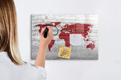 Magnetic marker board world map on brick wall