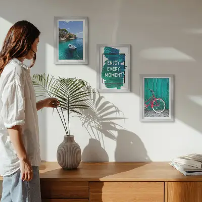 Photo frame wall with sea view, boat, bicycle, and inspirational inscription