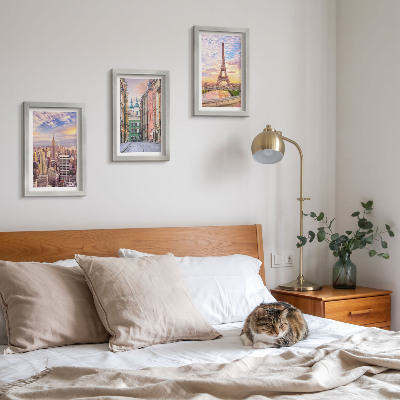 Photo frame wall View of the cities of New York, Paris and Warsaw at dusk