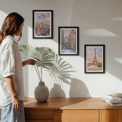 Photo frame wall View of the cities of New York, Paris and Warsaw at dusk