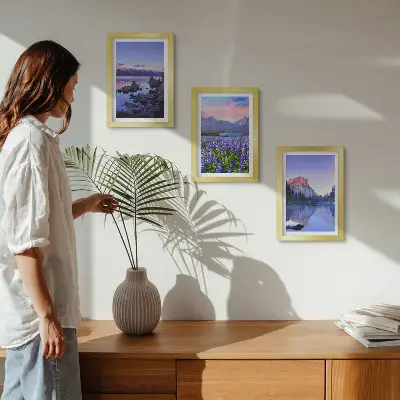 Mountain landscape triptych with water, sky, and a field of flowers in a frame