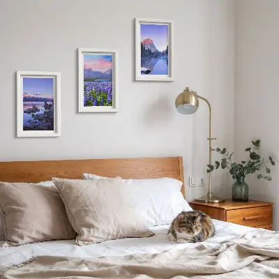 Mountain landscape triptych with water, sky, and a field of flowers in a frame