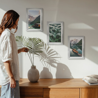 Photo frame wall Mountain landscapes with a lake, a boat, and a forest in the fog