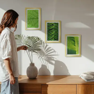 Photo frame wall with tropical leaves close-up motifs