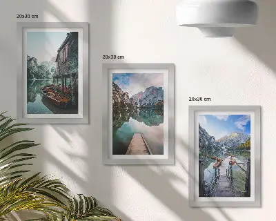 A quiet lake in the mountains with wooden boats framed triptych