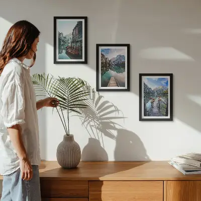 A quiet lake in the mountains with wooden boats framed triptych